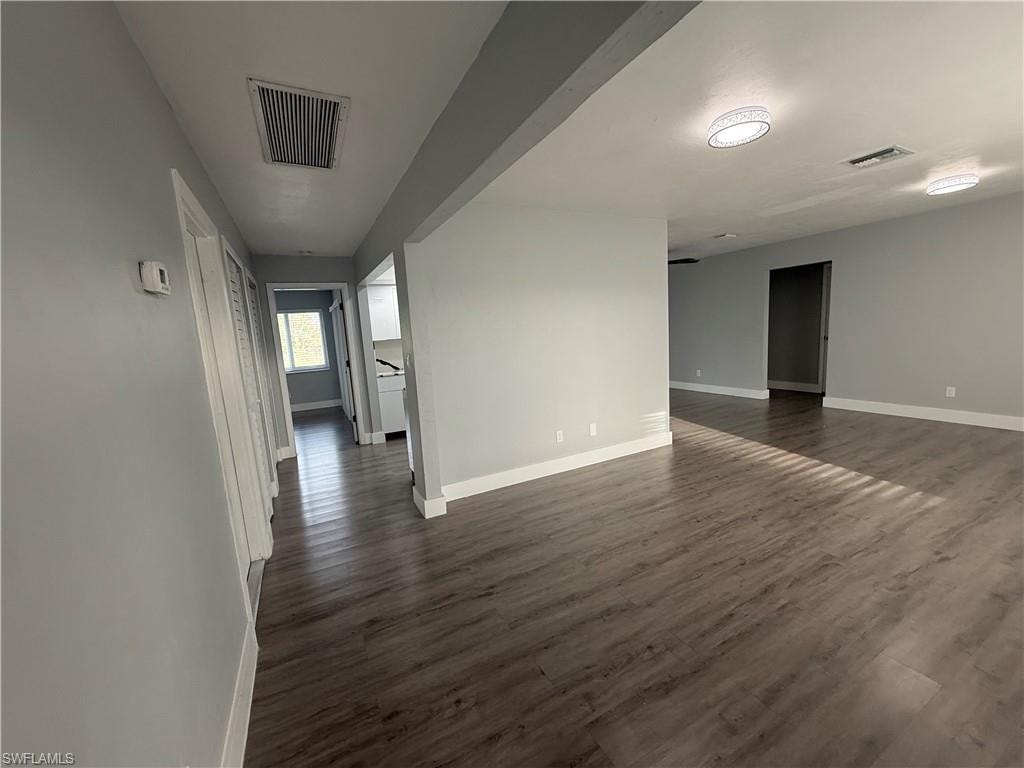Unfurnished room with dark wood finished floors