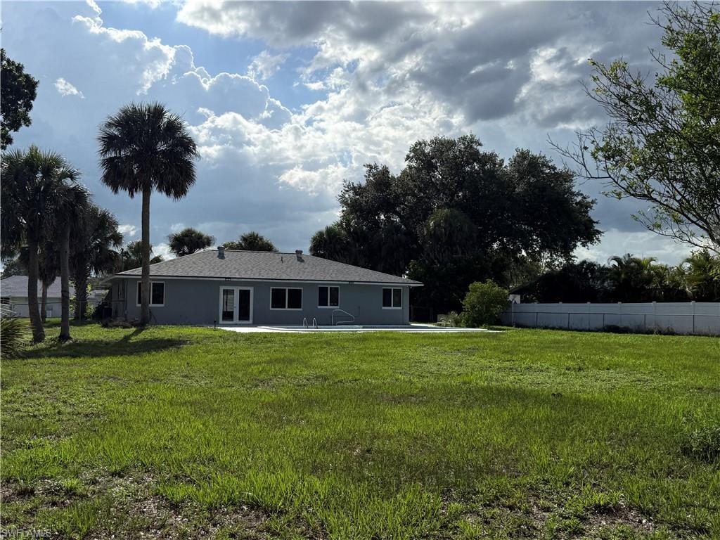 Rear view of property featuring stucco siding and a patio area
