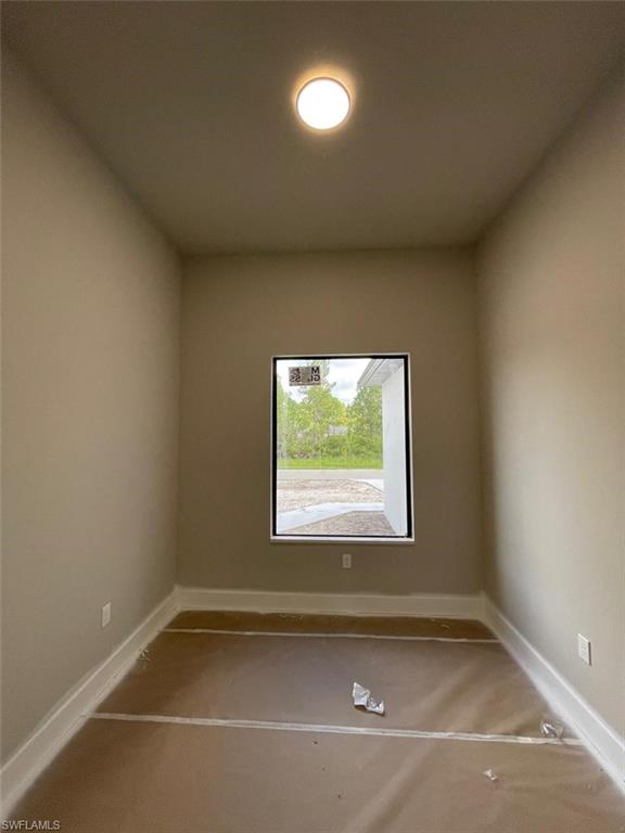 Unfurnished room featuring carpet floors and baseboards