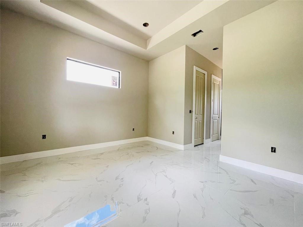 Spare room with baseboards, light marble finish flooring, and recessed lighting