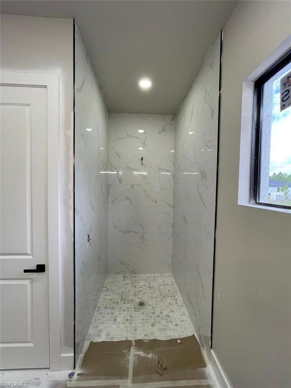 Bathroom with a marble finish shower
