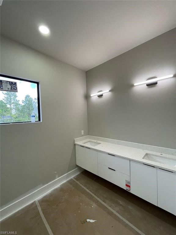 Bathroom with double vanity and recessed lighting