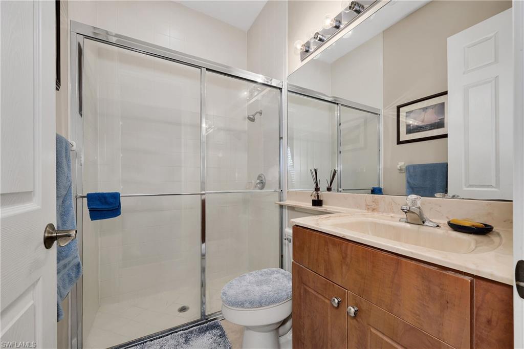 Full bath featuring vanity and a shower stall