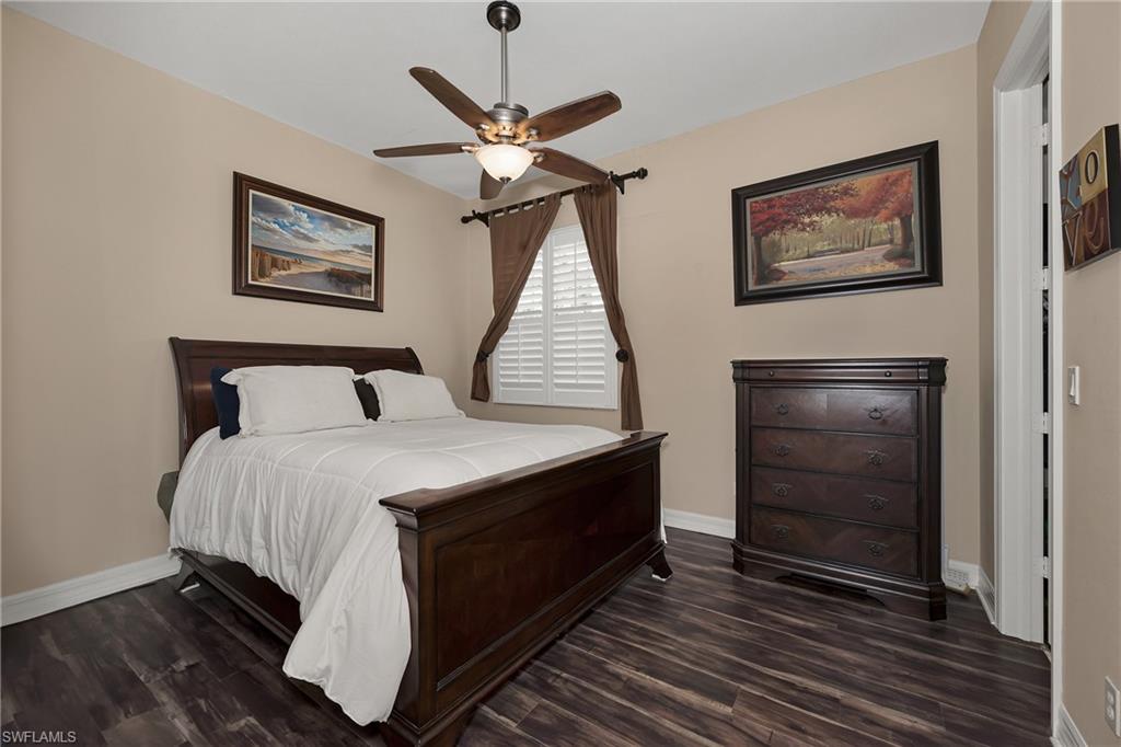 Bedroom featuring dark wood-type flooring and ceiling fan