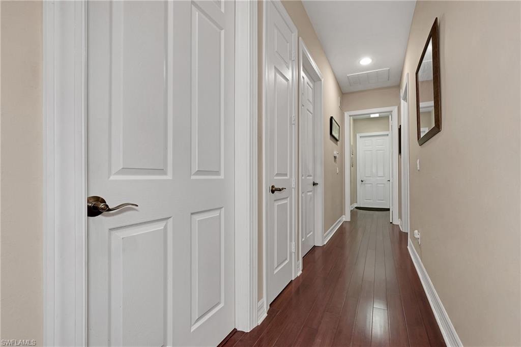 Hallway featuring dark wood finished floors and recessed lighting