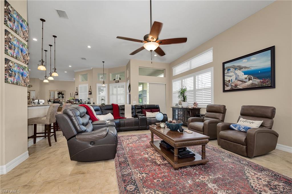 Living area featuring ceiling fan and recessed lighting