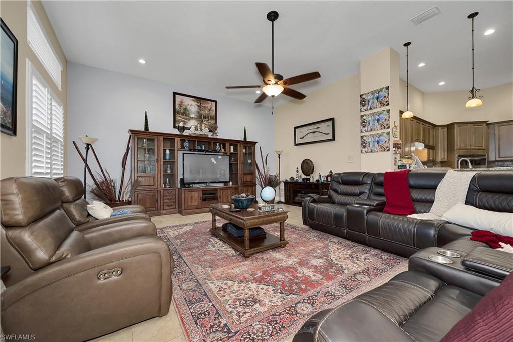 Living area featuring ceiling fan, light tile patterned flooring, and recessed lighting