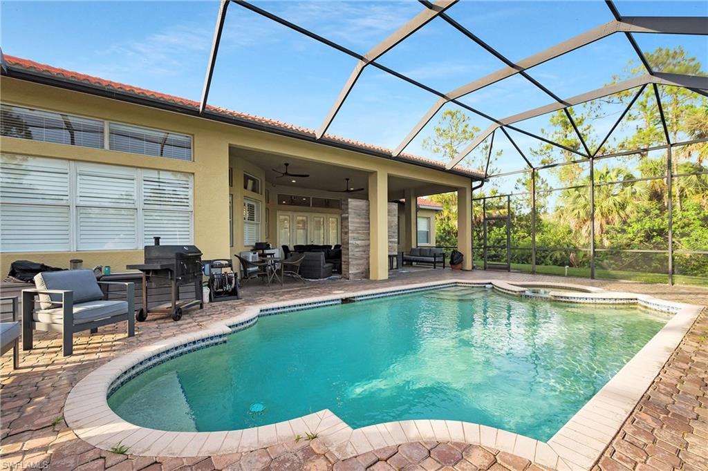 View of pool featuring a patio, an outdoor hangout area, and a lanai