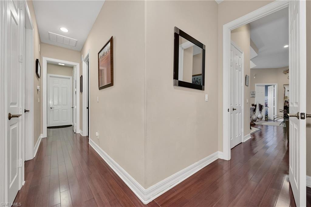 Hall featuring dark wood-style floors and recessed lighting