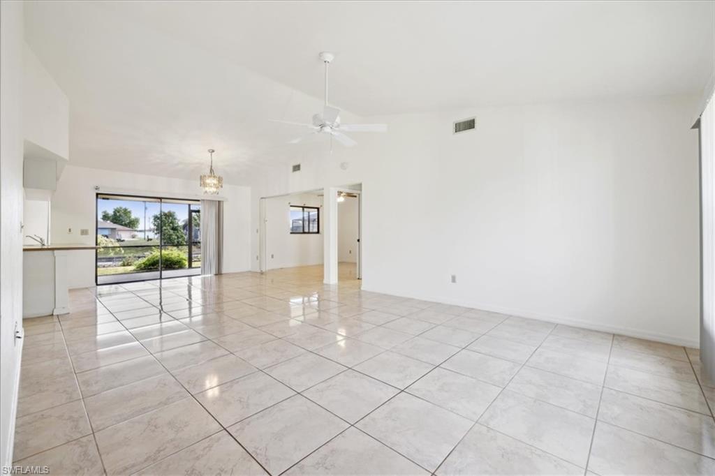View of property hidden behind natural elements with a front yard, concrete driveway, and a garage