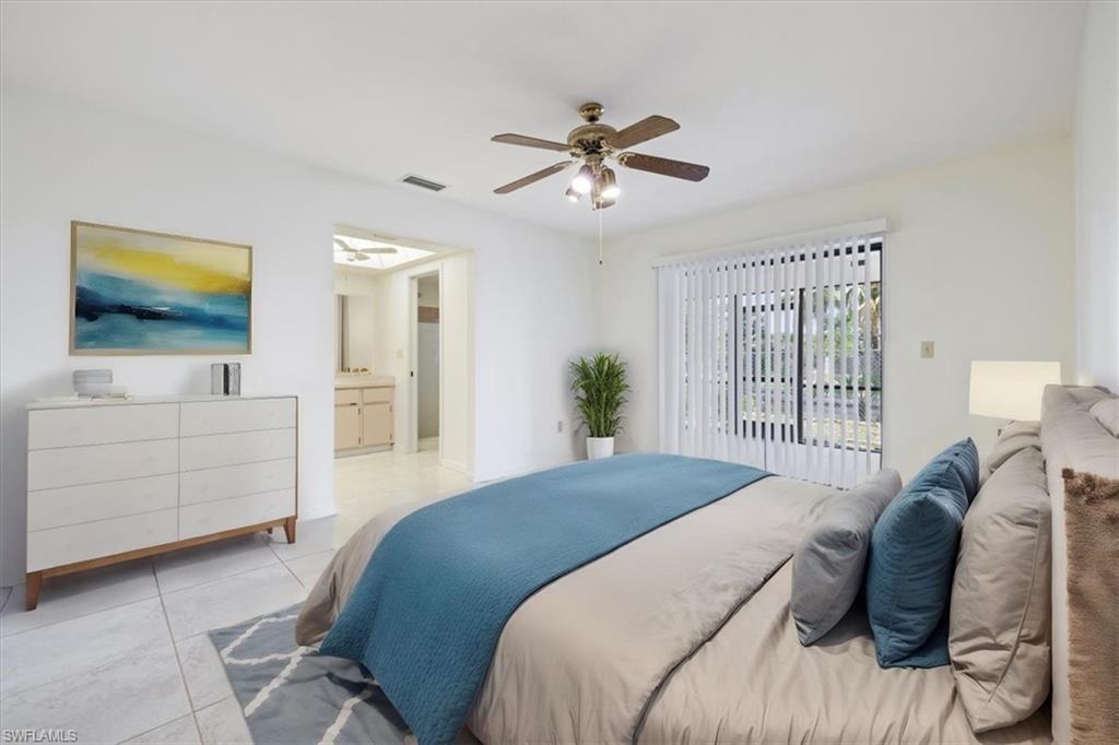 Empty room with light tile patterned floors, ceiling fan, and baseboards