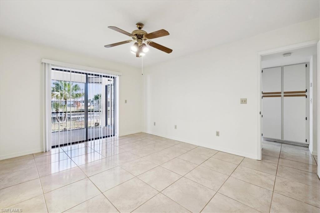 Unfurnished lanai featuring a ceiling fan, and a gulf access waterfront view.