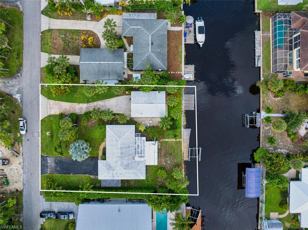 Aerial overview of property's location with property boundaries highlighted and a large body of water