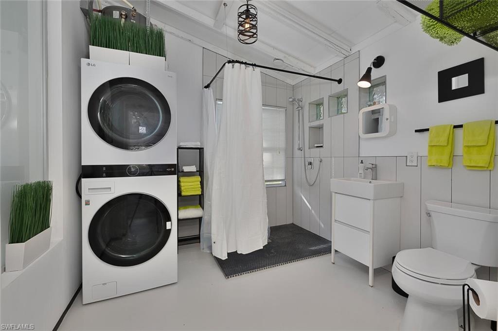 Laundry room featuring stacked washer and clothes dryer