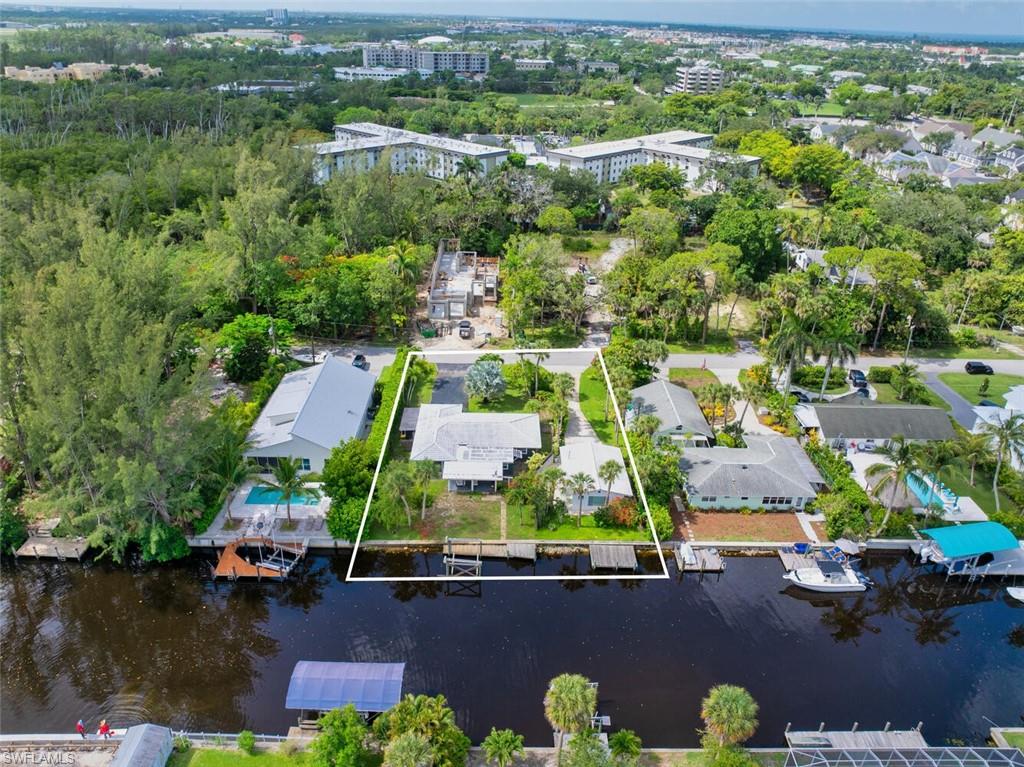 Aerial overview of property's location with a nearby body of water and property boundaries highlighted