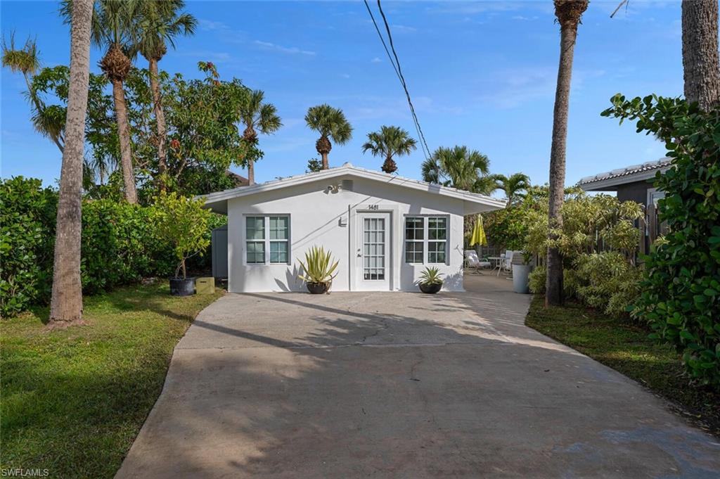 View of front of property with stucco siding and concrete driveway