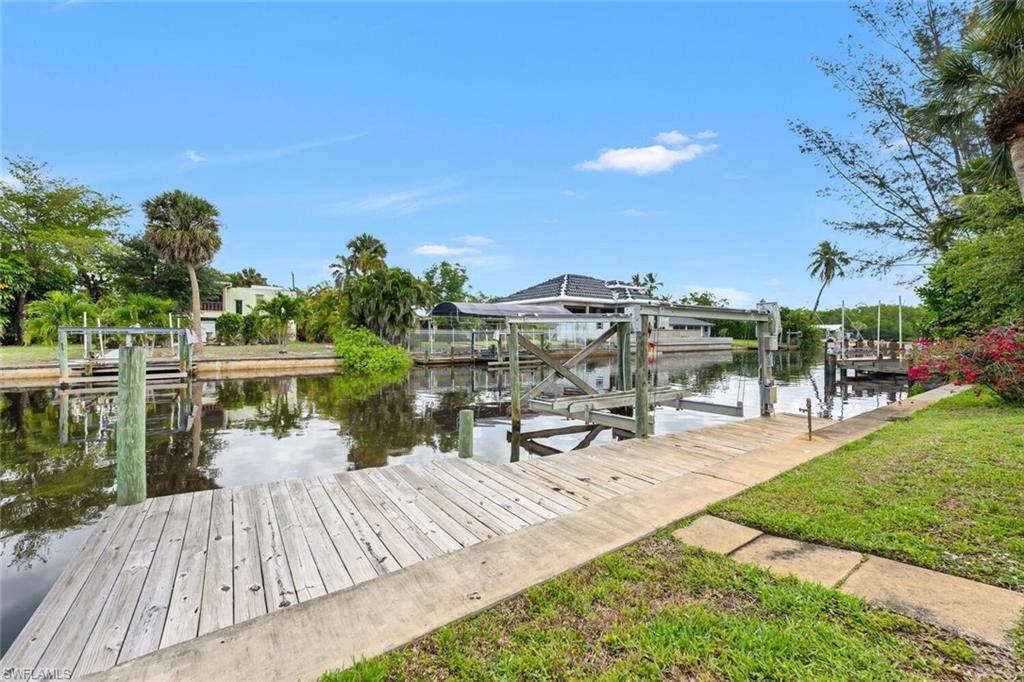 Dock with boat lift and a water view