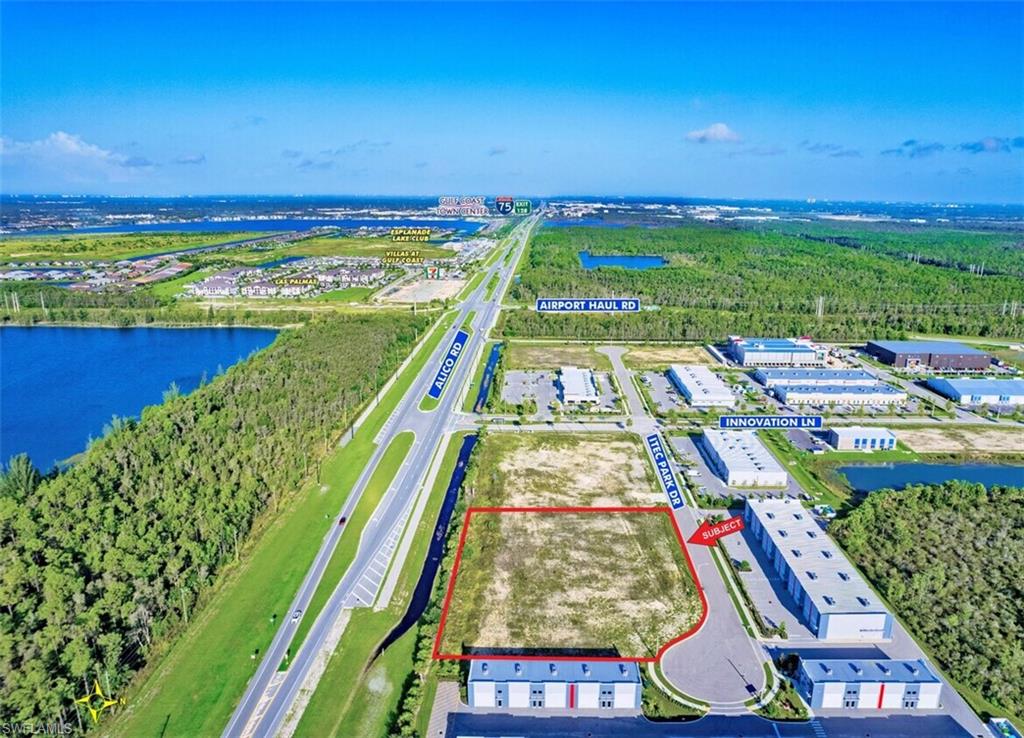 Aerial view of property and surrounding area with property parcel outlined and a large body of water