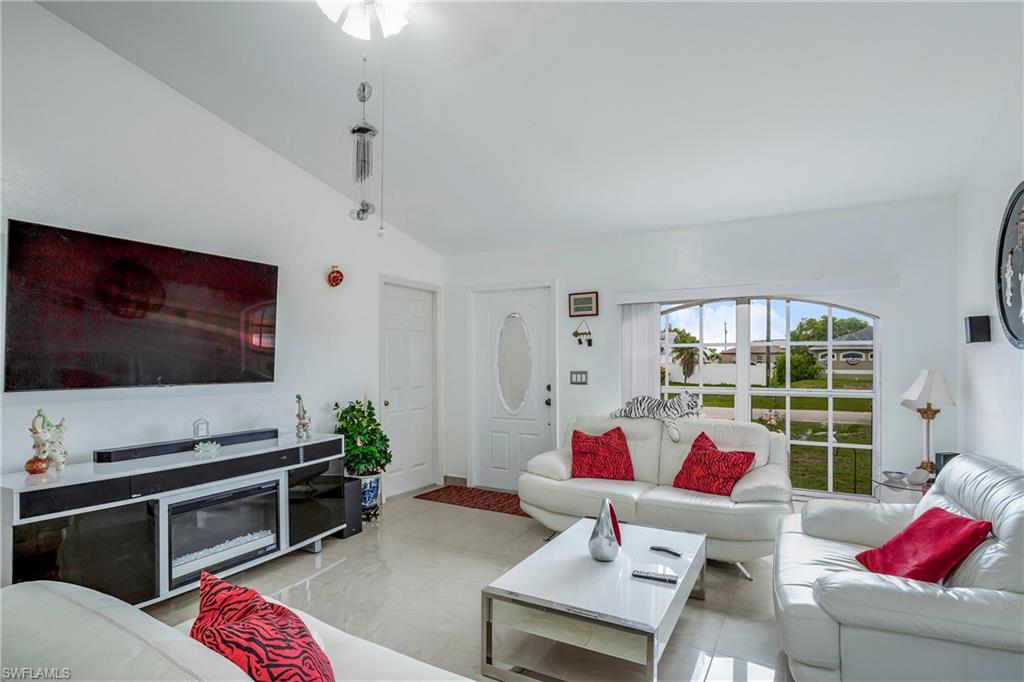 Living area featuring high vaulted ceiling and ceiling fan