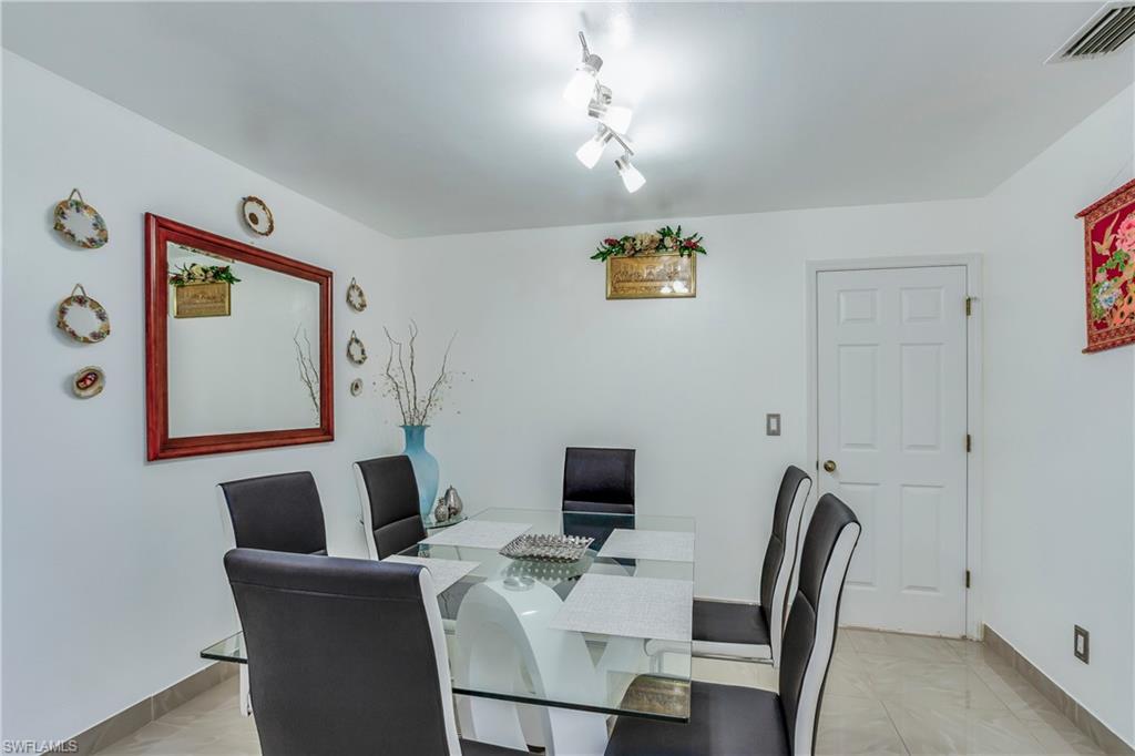 Dining space with baseboards and light marble finish floors