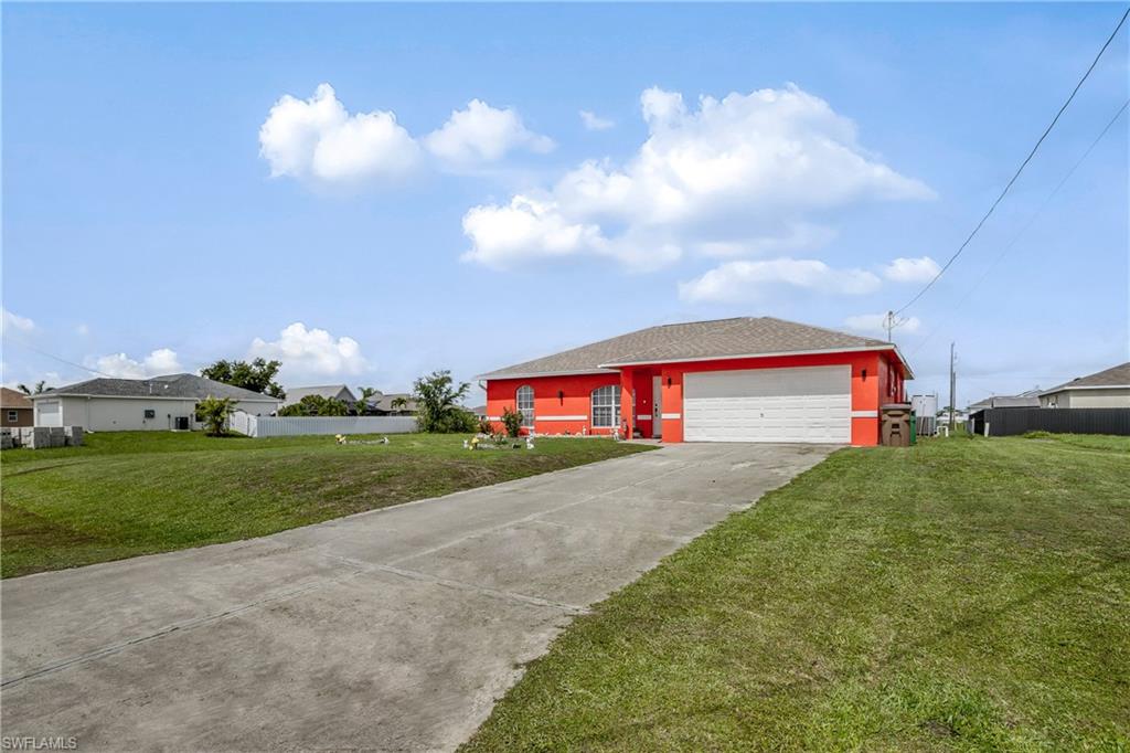 Ranch-style house with concrete driveway and a garage