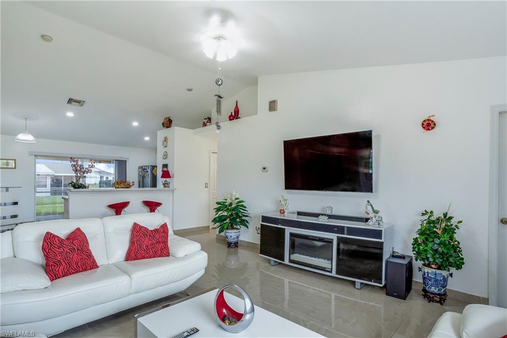 Living area featuring lofted ceiling