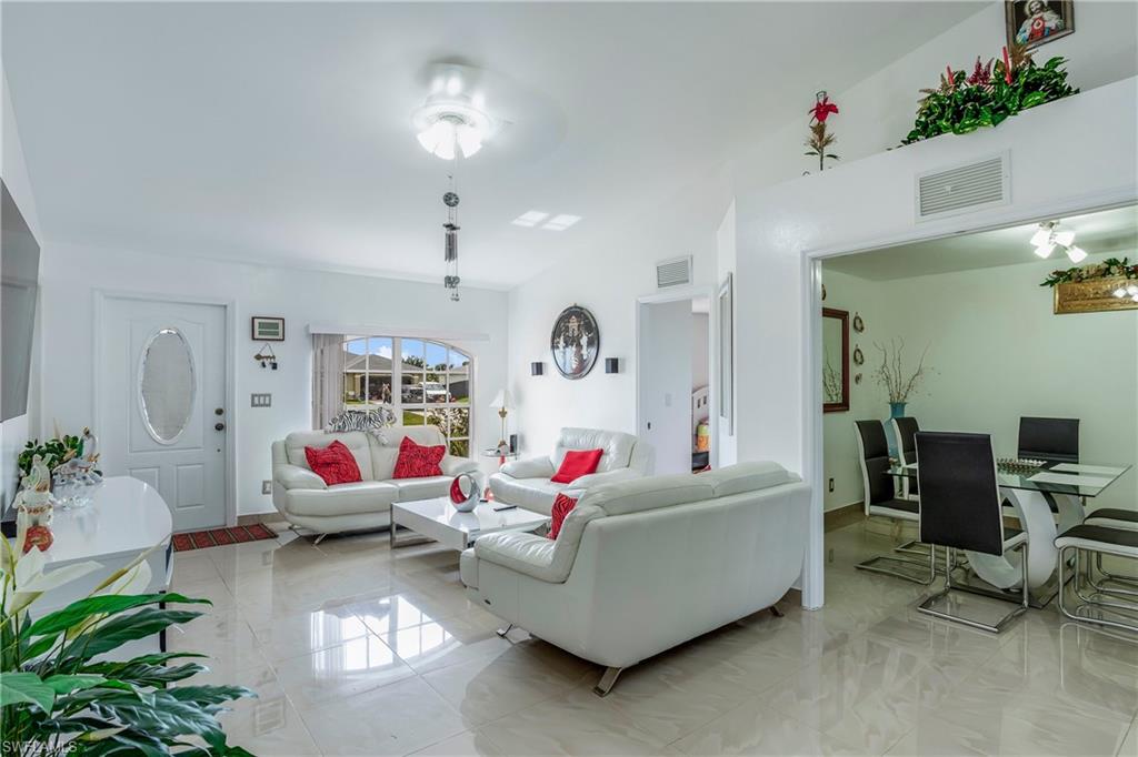 Living area featuring light marble finish floors and baseboards