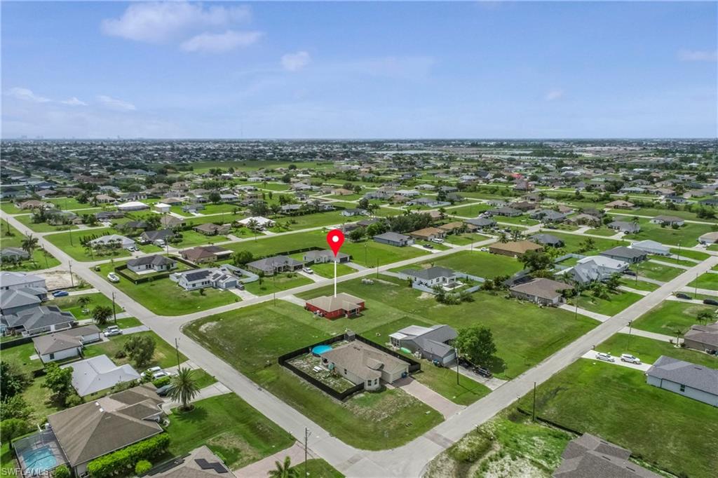 Aerial overview of property's location with nearby suburban area