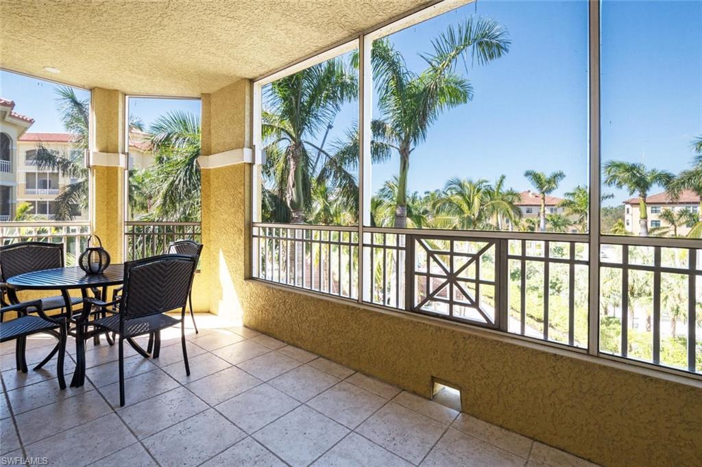 Outdoor screened dining overlooking palm trees