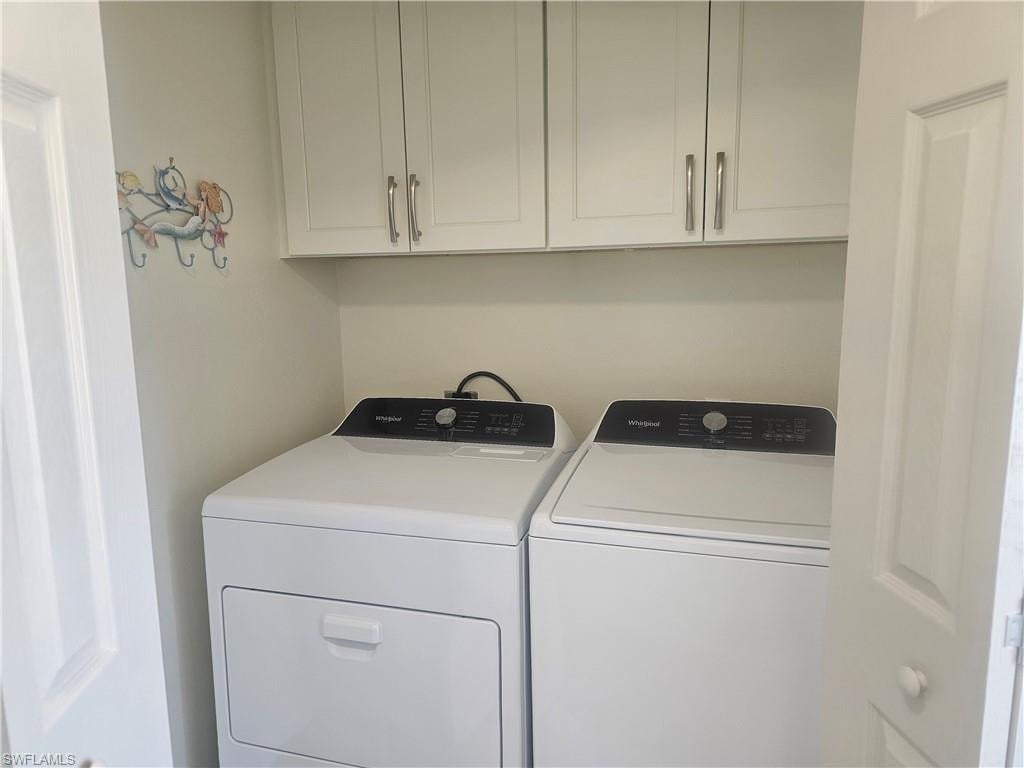Washroom with separate washer and dryer and cabinet space