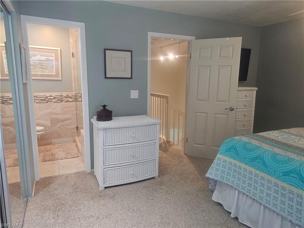Bedroom with carpet flooring and ensuite bathroom