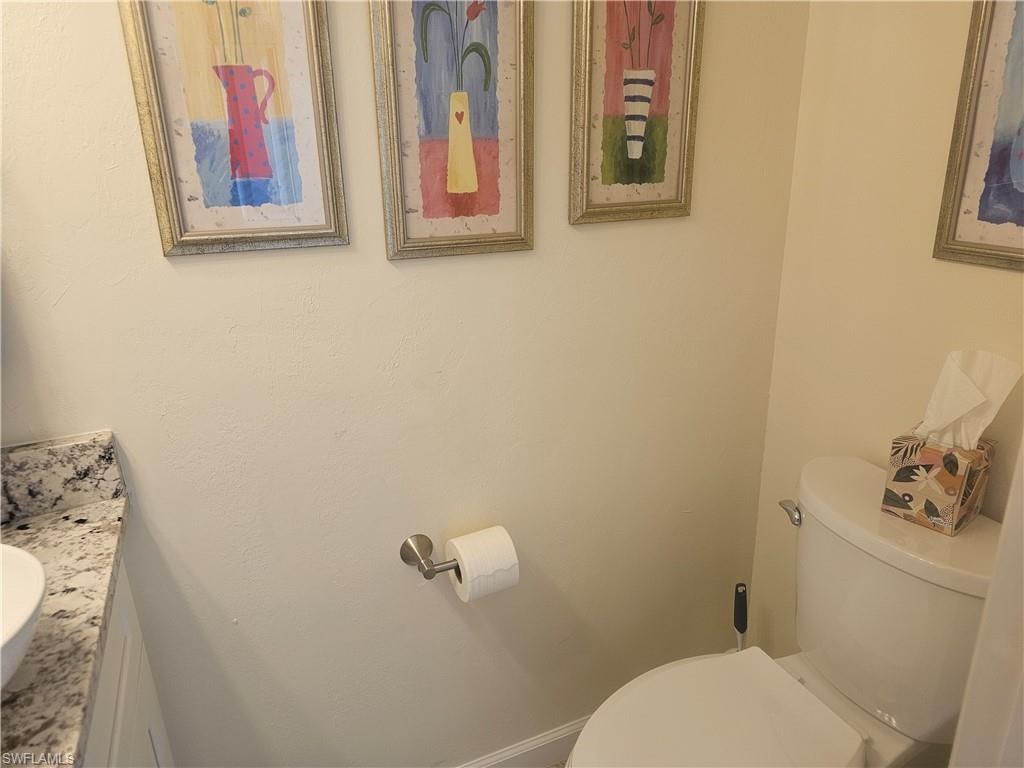 Half bathroom featuring toilet and vanity