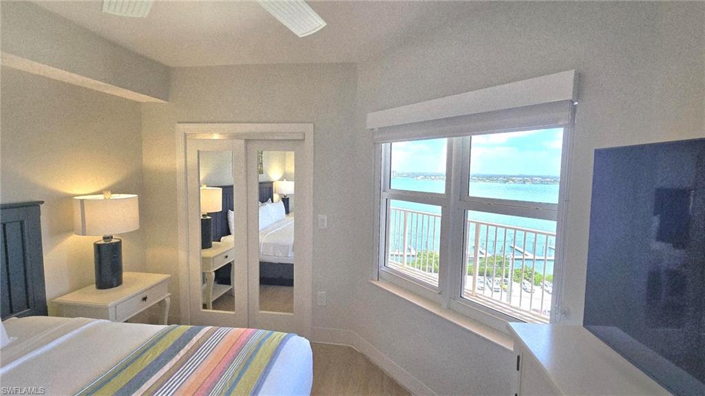 Bedroom featuring a water view and wood finished floors