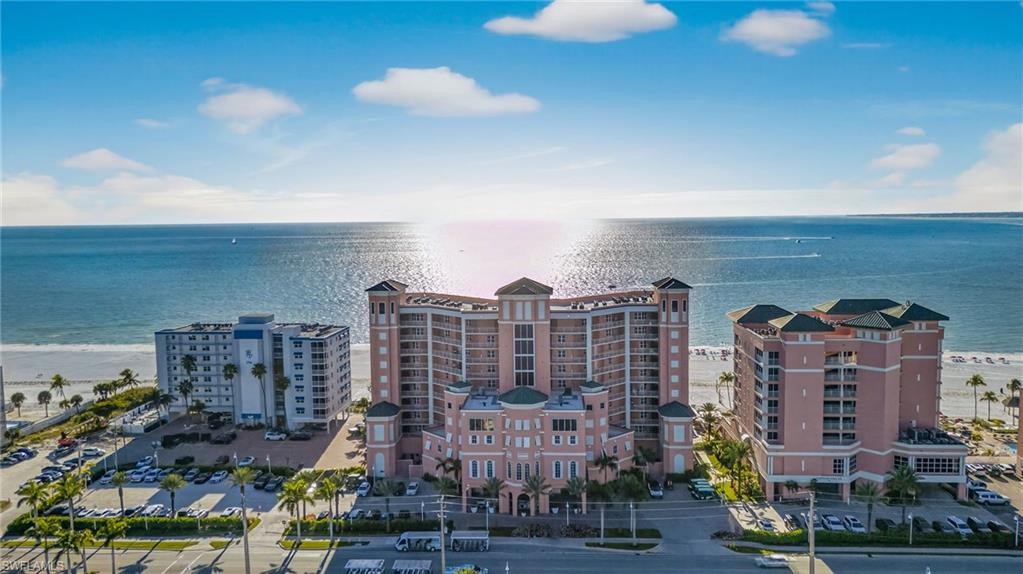 Drone / aerial view of a nearby body of water and apartment complex / building