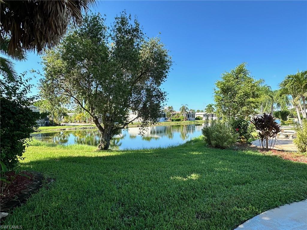 View of green lawn featuring a water view