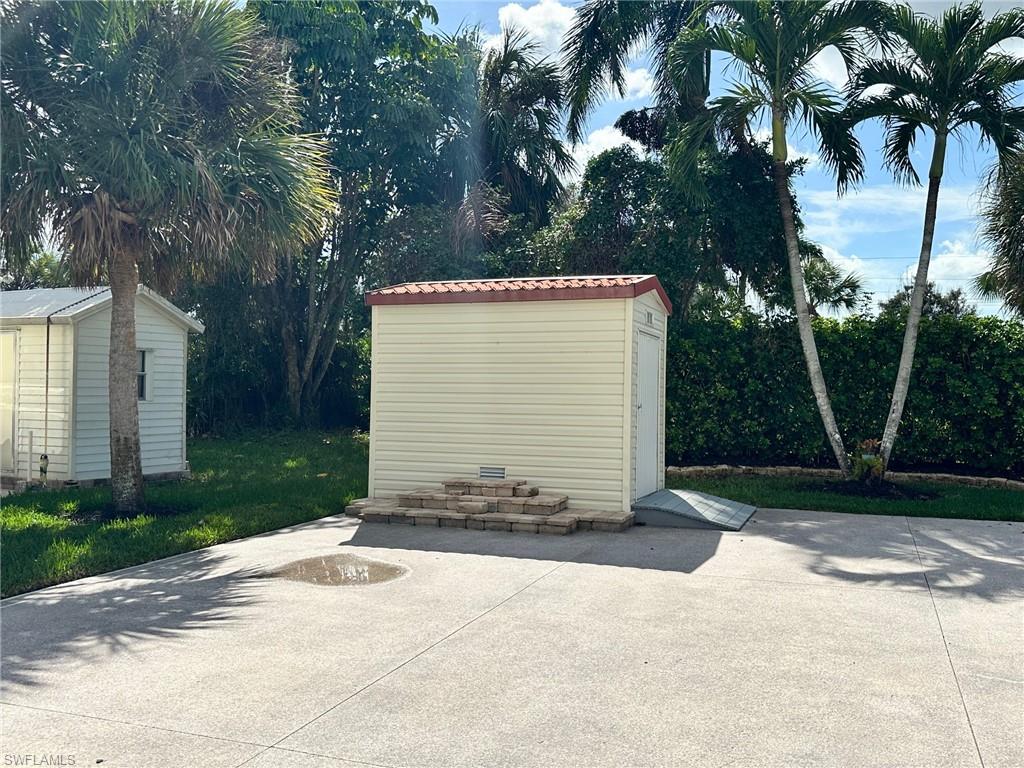 View of patio with a shed