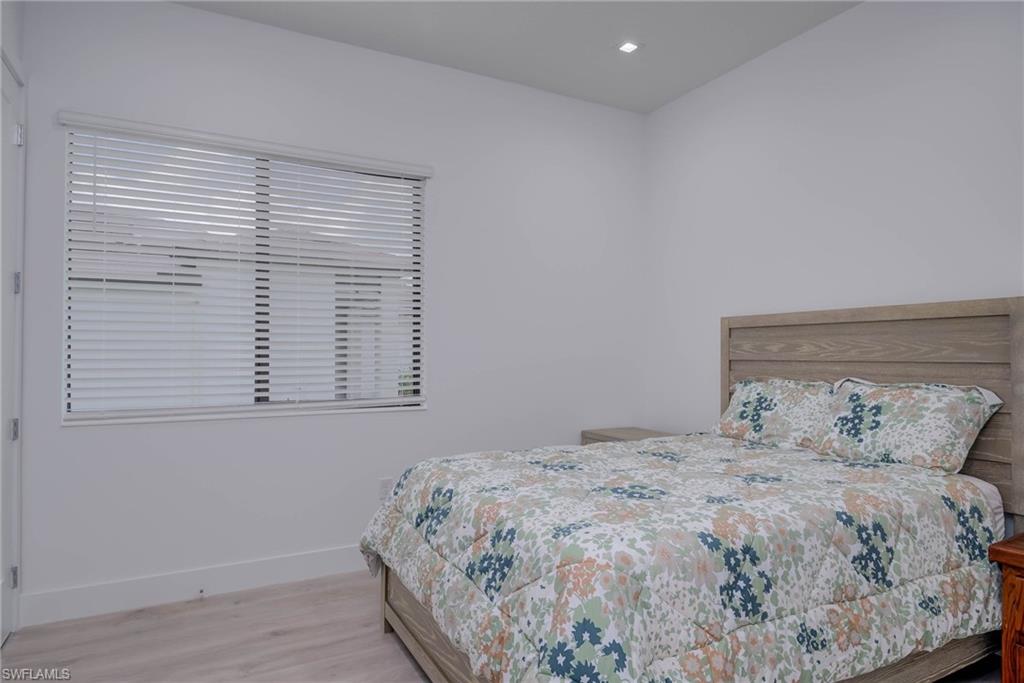 Bedroom with wood finished floors and recessed lighting