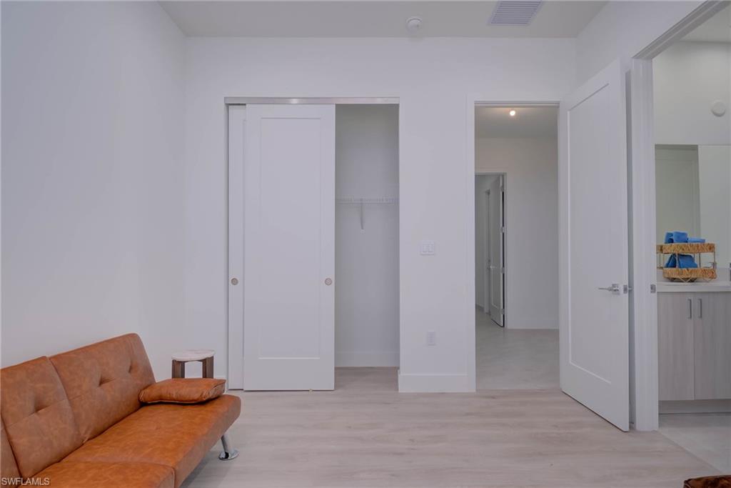 Living area with light wood finished floors and baseboards