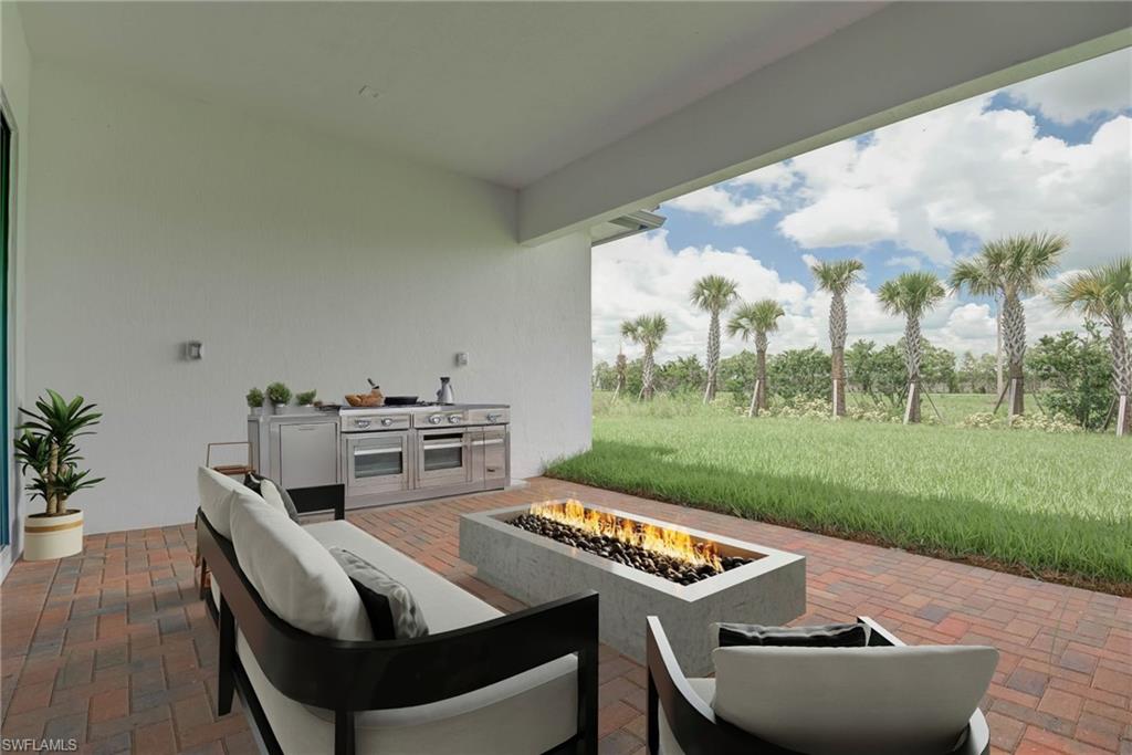 View of patio featuring an outdoor living space with a fire pit and exterior kitchen- digitally staged