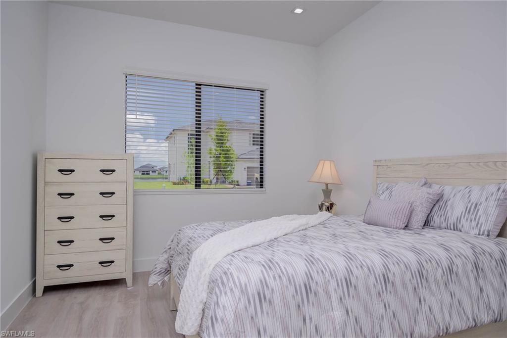 Bedroom featuring baseboards and light wood-type flooring