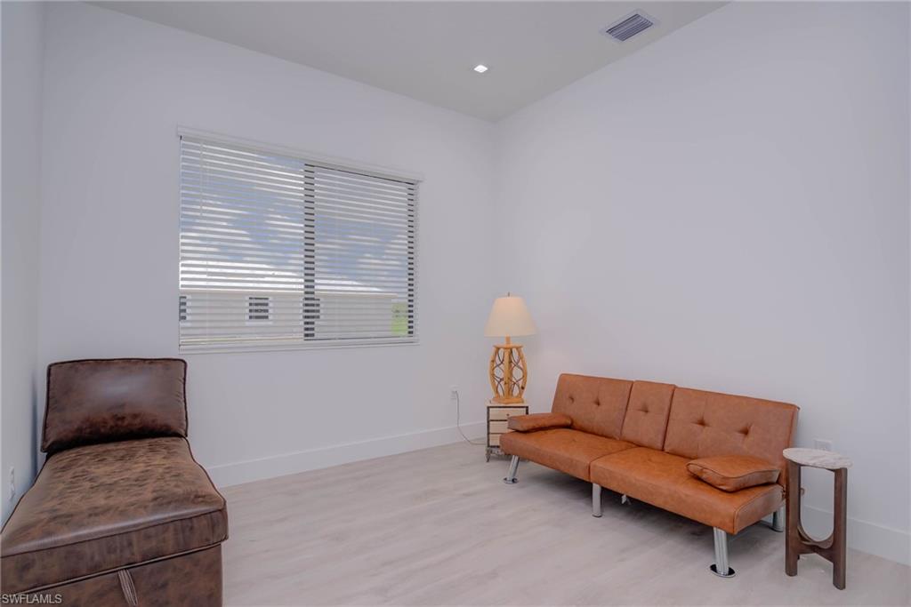 Living area featuring light wood finished floors and baseboards