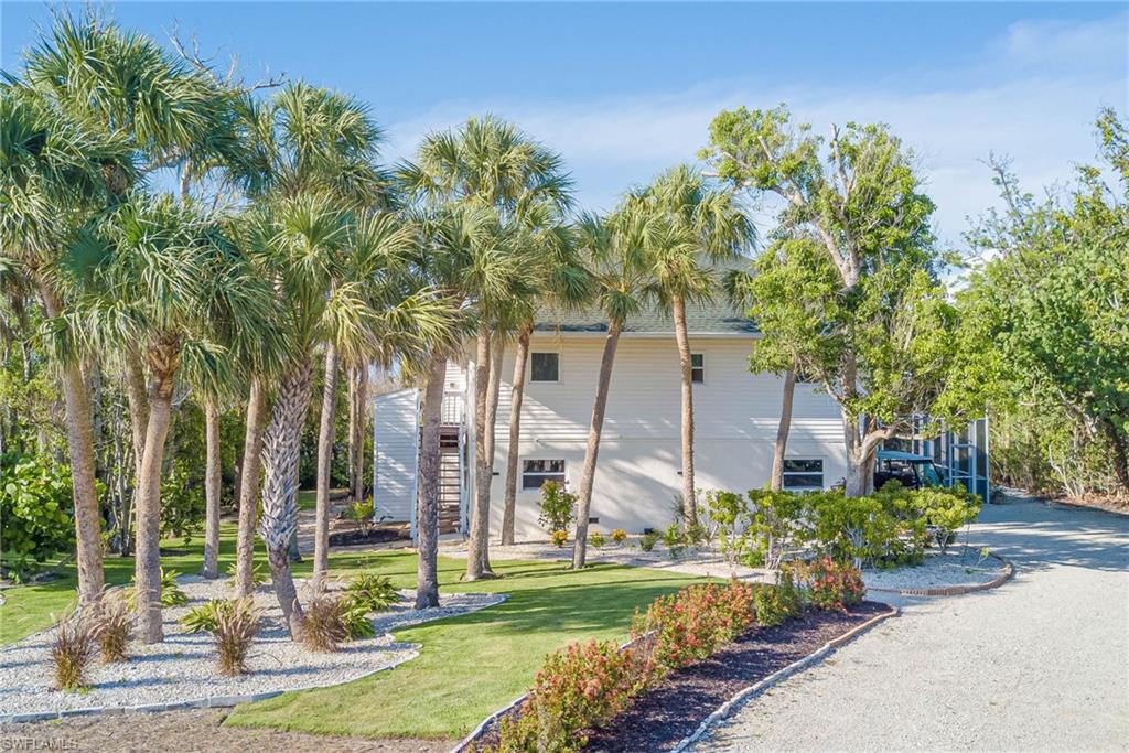 NEW landscaping, NEW Impact windows, NEW stairs up to the 2nd level, plenty of space in the driveway to park and golf cart! 2+car garage, screened-in pool and patio area, bonus lower level, and so much more!