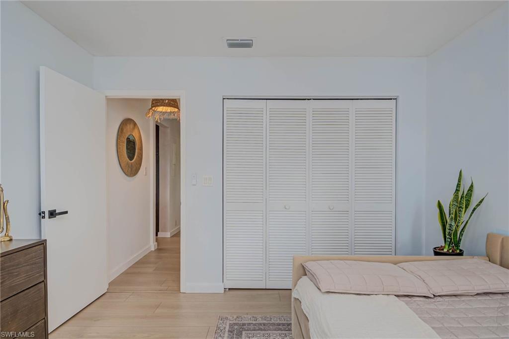 Bedroom featuring light wood-type flooring and a closet