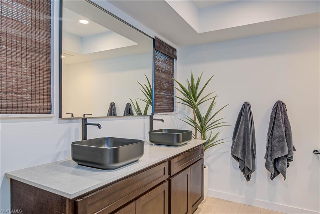 Remodeled with NEW windows, NEW shower, with double vanity, a raised ceiling, and recessed lighting
