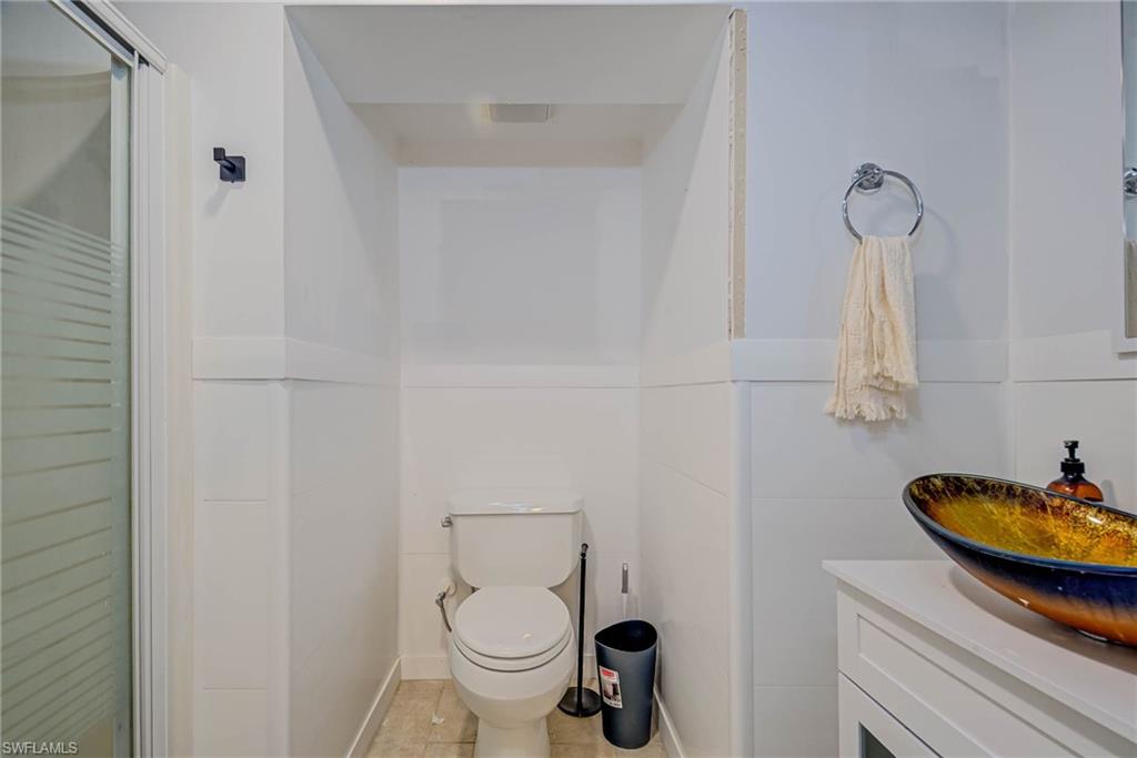 Lower level - full bathroom -  featuring vanity, tile patterned flooring, and an enclosed shower