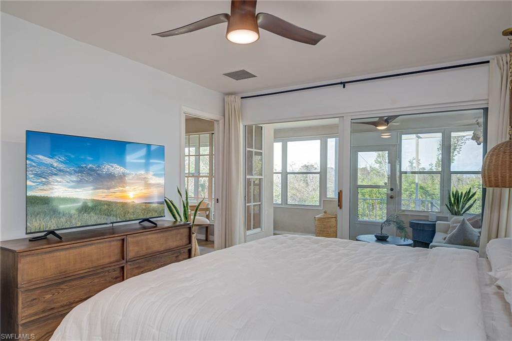Bedroom featuring access to outside with pocket door into living area/kitchen/dining