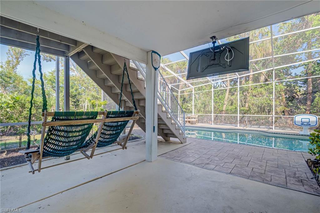 View of patio / terrace with stairway and an outdoor pool