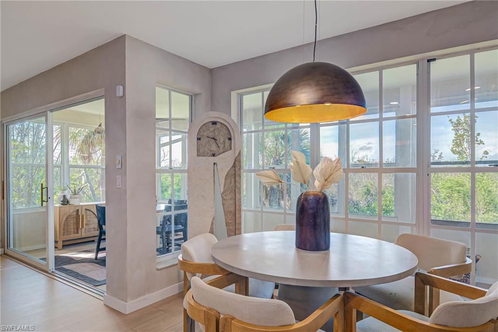 Dining space with light wood-style floors and healthy amount of natural light