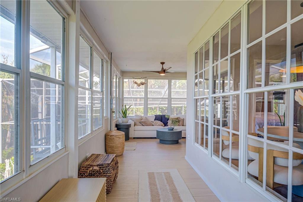 Sunroom with plenty of natural light, an outdoor hangout area, and ceiling fan