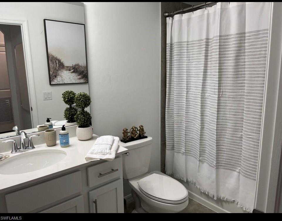 Bathroom with vanity and shower / bath combination with curtain